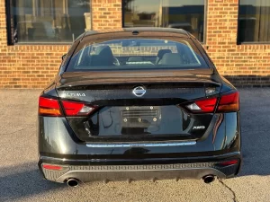 2019 Nissan Altima parked outdoors, highlighting its aerodynamic curves and contemporary styling.