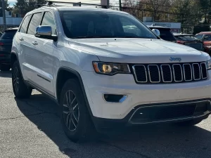 2019 Jeep Grand Cherokee parked on a scenic landscape, showcasing its sleek design and rugged off-road capability.