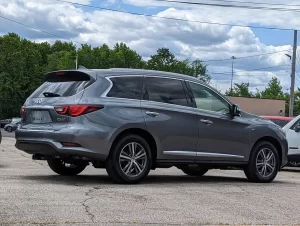 A sleek and stylish 2020 INFINITI QX60 SUV in a sophisticated setting, showcasing its premium design and elegance.