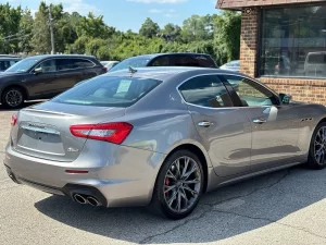 A sleek 2019 Maserati Ghibli SQ4 GranSport in gray, showcasing its elegant design, bold curves, and luxurious appeal against a clean background.