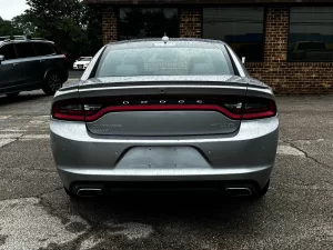 A sleek 2016 Dodge Charger in motion, showcasing its bold design, powerful stance, and modern styling.