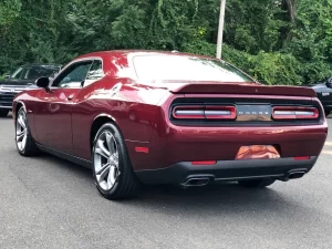 The 2021 Dodge Challenger in a sleek, dynamic pose showcasing its bold design and powerful stance.