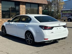 A sleek 2019 Lexus GS 350 sedan parked on a scenic road, showcasing its luxury design and modern features.