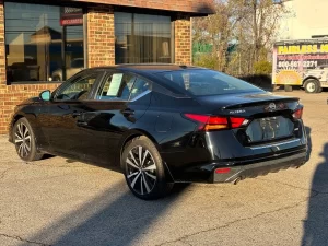 2019 Nissan Altima parked outdoors, highlighting its aerodynamic curves and contemporary styling.