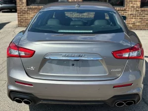 A sleek 2019 Maserati Ghibli SQ4 GranSport in gray, showcasing its elegant design, bold curves, and luxurious appeal against a clean background.