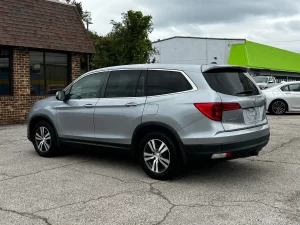 A sleek 2017 Honda Pilot SUV in a neutral setting, showcasing its robust design and spacious family-friendly appeal.