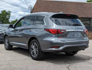 A sleek and stylish 2020 INFINITI QX60 SUV in a sophisticated setting, showcasing its premium design and elegance.