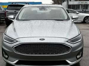 2020 Ford Fusion Titanium showcasing its stylish design and premium features in a modern outdoor setting.