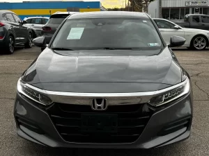 A sleek 2018 Honda Accord LX showcasing its modern design and premium features in a dynamic setting.