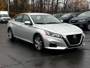 2020 Nissan Altima parked on a scenic road, showcasing its sleek design and modern features.