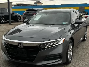 A sleek 2018 Honda Accord LX showcasing its modern design and premium features in a dynamic setting.