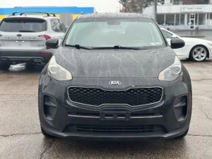 A 2018 Kia Sportage LX parked, showcasing its sleek design, modern features, and stylish wheels in a dynamic setting.