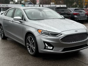 2020 Ford Fusion Titanium showcasing its stylish design and premium features in a modern outdoor setting.