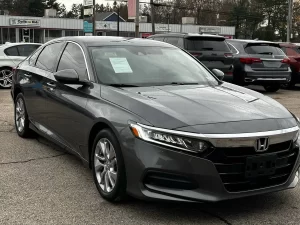 A sleek 2018 Honda Accord LX showcasing its modern design and premium features in a dynamic setting.