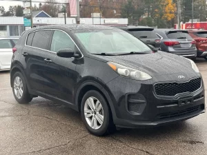 A 2018 Kia Sportage LX parked, showcasing its sleek design, modern features, and stylish wheels in a dynamic setting.