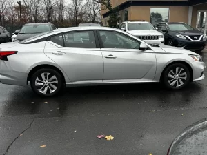 2020 Nissan Altima parked on a scenic road, showcasing its sleek design and modern features.