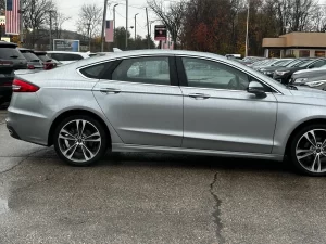 2020 Ford Fusion Titanium showcasing its stylish design and premium features in a modern outdoor setting.