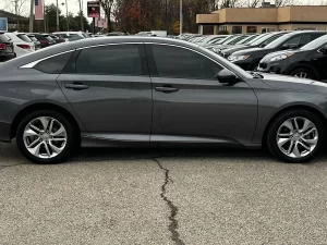 A sleek 2018 Honda Accord LX showcasing its modern design and premium features in a dynamic setting.