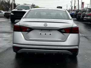 2020 Nissan Altima parked on a scenic road, showcasing its sleek design and modern features.