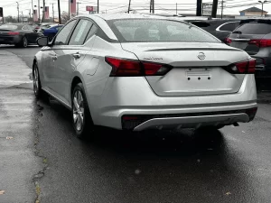 2020 Nissan Altima parked on a scenic road, showcasing its sleek design and modern features.