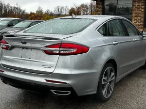 2020 Ford Fusion Titanium showcasing its stylish design and premium features in a modern outdoor setting.